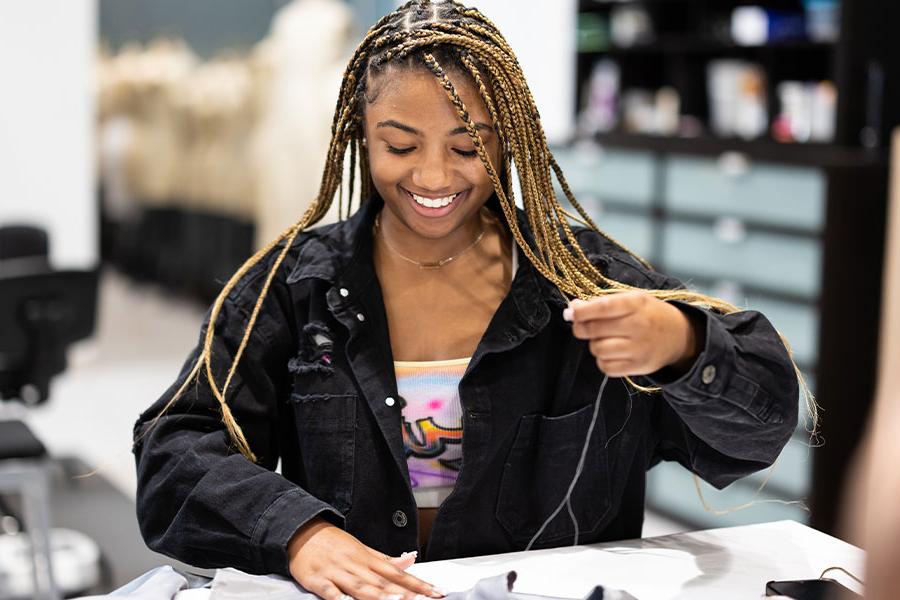 ksu arts student working on a costume.